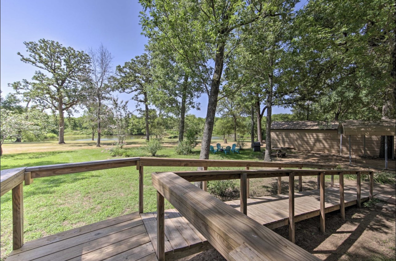10630 River Ranch Road Kemp, TX 75143 - Photo 30 of 42 Elevated outdoor deck overlooking the acreage and surrounding trees.