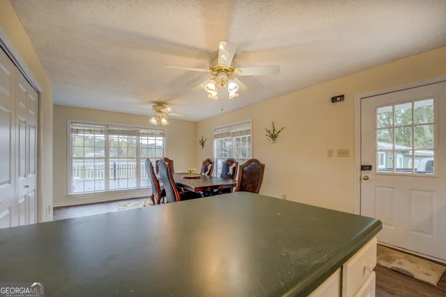 a kitchen with granite countertop white cabinets and white appliances