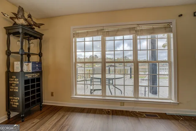 a view of a hallway with fireplace and wooden floor