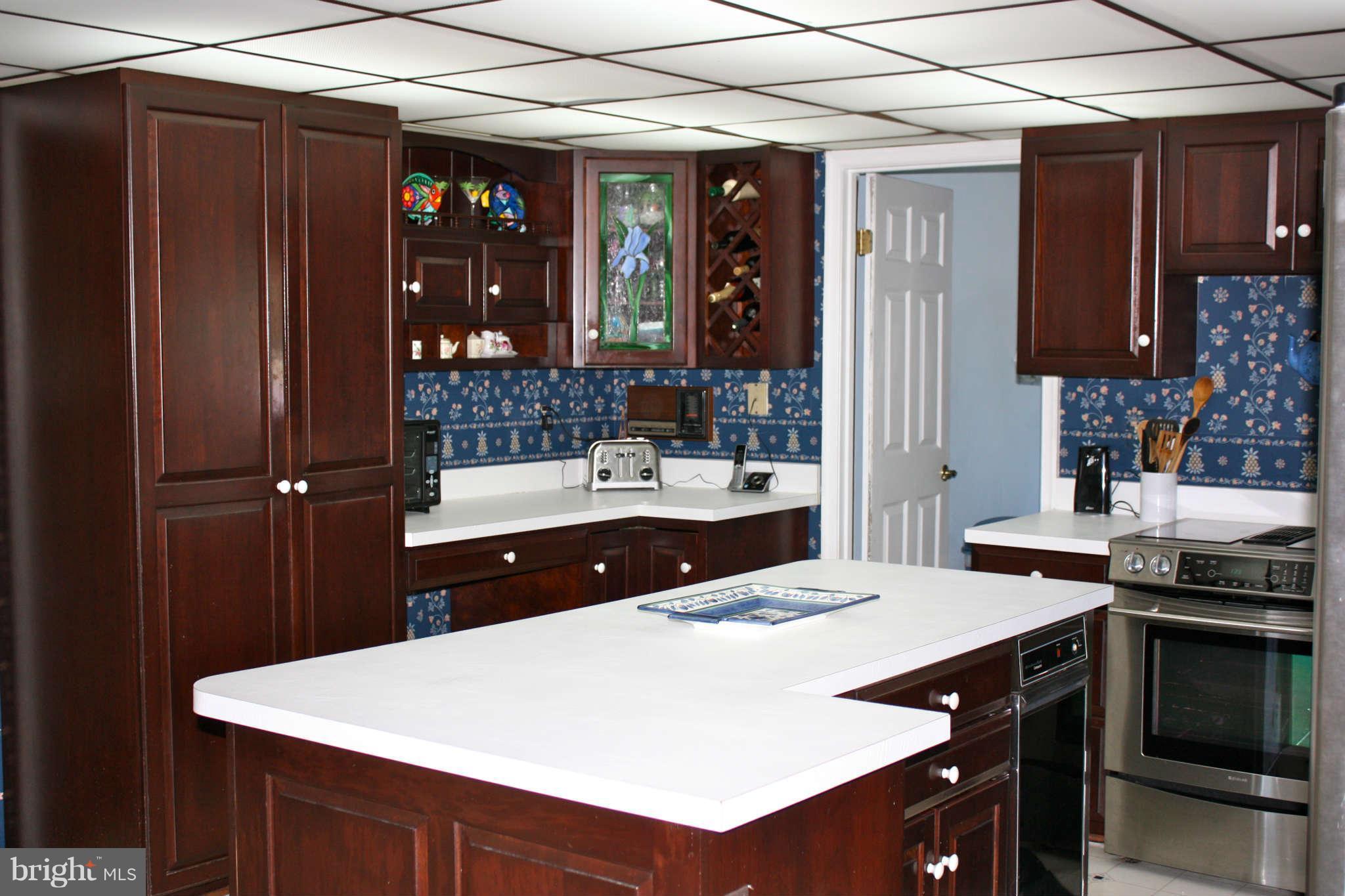 5004 Sweet Air Road Baldwin, MD 21013 - Photo 8 of 29 a kitchen with a sink refrigerator and cabinets
