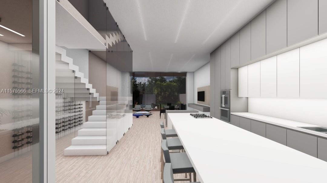 70 Northwest 53rd Street Miami, FL 33127 - Photo 6 of 7 a large white kitchen with a large window and furniture