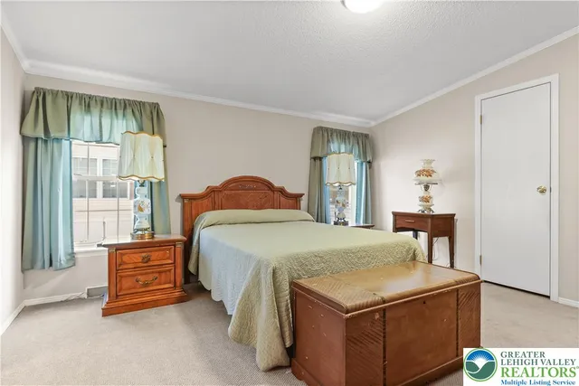 a view of a house with a yard and potted plants