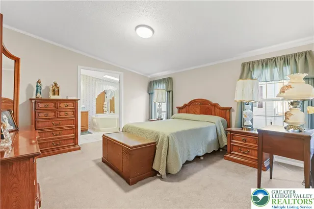 a view of a house with a big yard and large trees