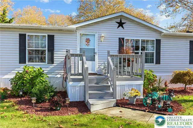 a living room with furniture a chandelier and a window