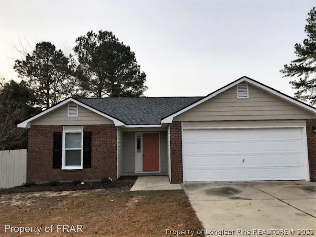 6140 Rhemish Drive Fayetteville, NC 28304 - Photo 1 of 12 a front view of a house with a yard