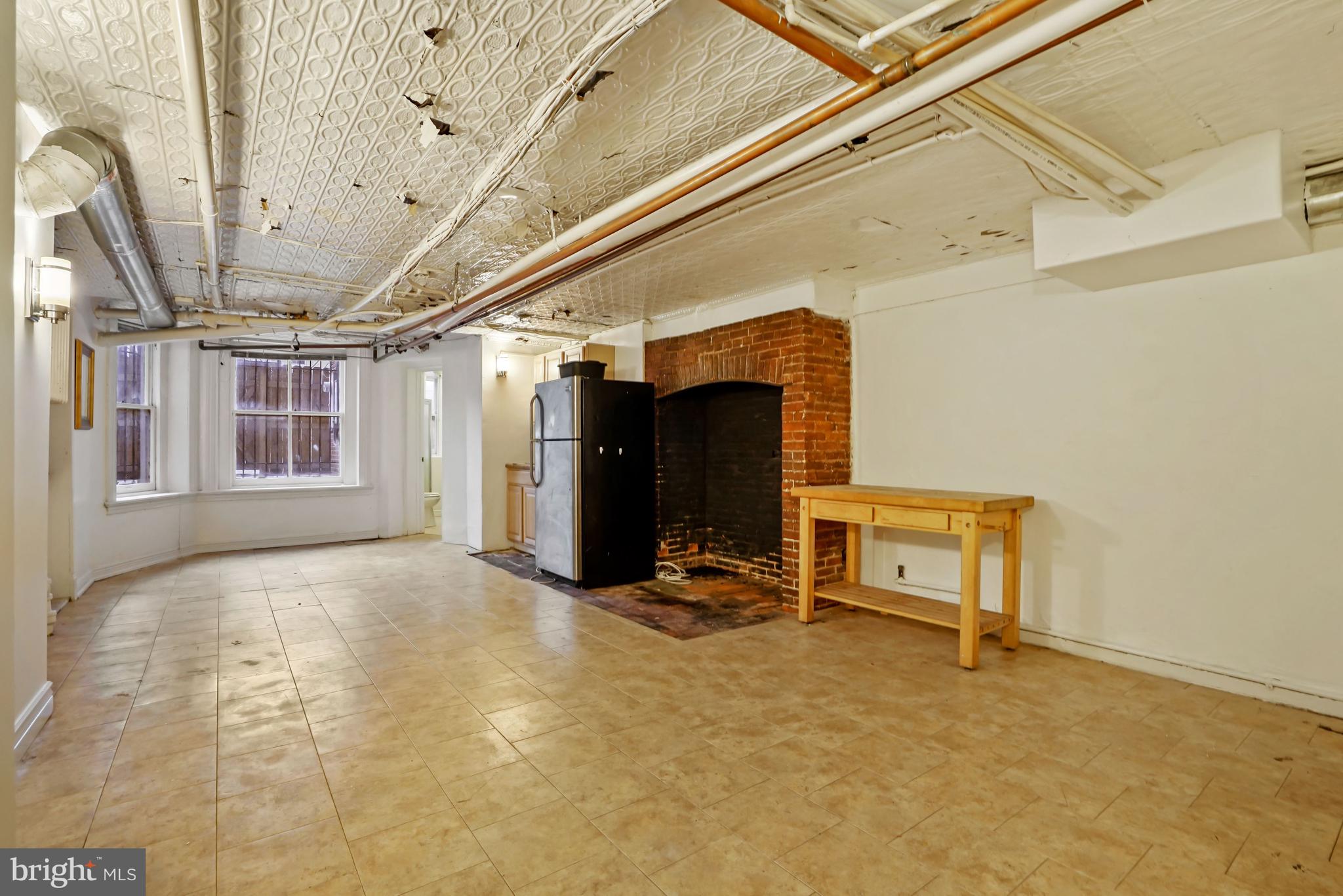 937 St Paul Street Baltimore, MD 21202 - Photo 48 of 53 Open Space w/Original Brick Hearth and Tin Ceiling