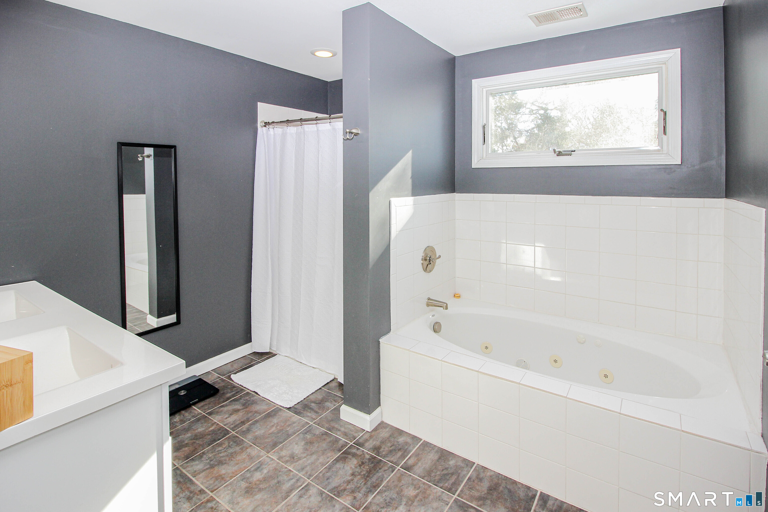 235 Lucille Street Newington, CT 06111 - Photo 25 of 35 a bathroom with a bathtub and a window