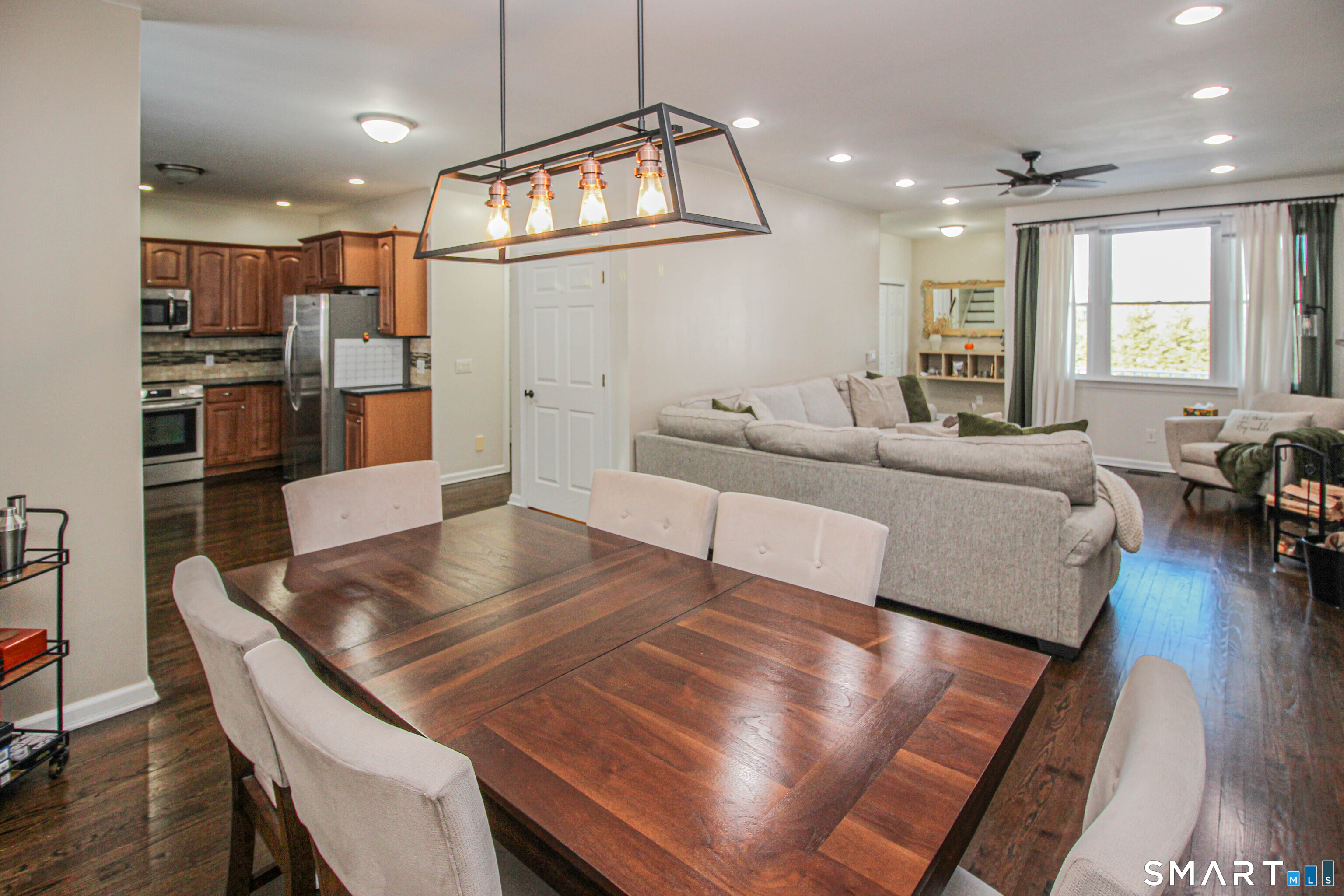 235 Lucille Street Newington, CT 06111 - Photo 8 of 35 a living room with kitchen view and a dining table with wooden floor