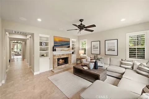 a living room with furniture fireplace and flat screen tv