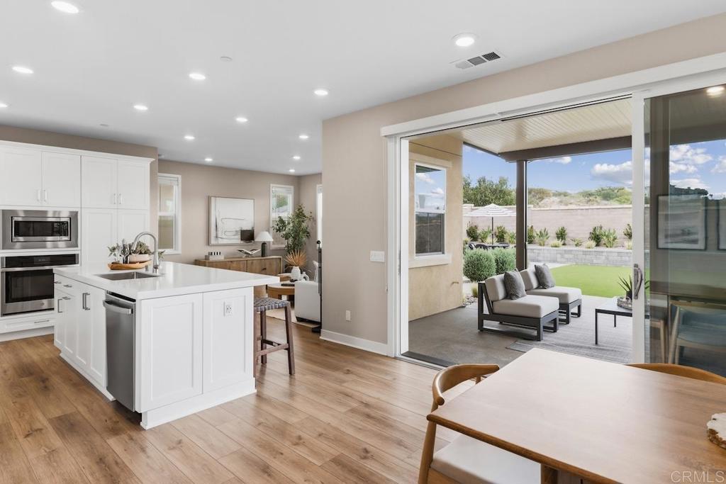 6675 Agave Circle Carlsbad, CA 92011 - Photo 1 of 1 a kitchen with stainless steel appliances granite countertop a stove top oven a sink and a refrigerator