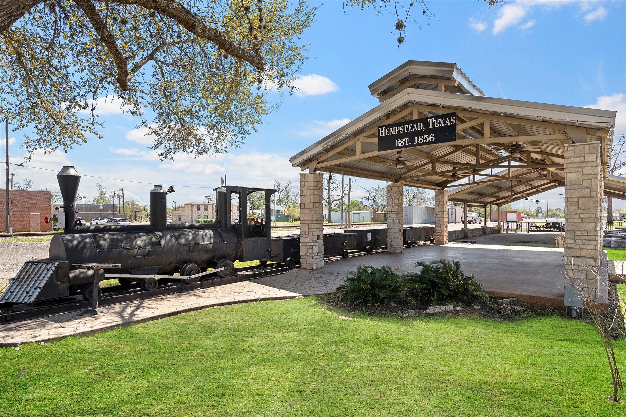 330 3rd Street Hempstead, TX 77445 - Photo 13 of 13 a view of a house with a big yard potted plants and a large tree