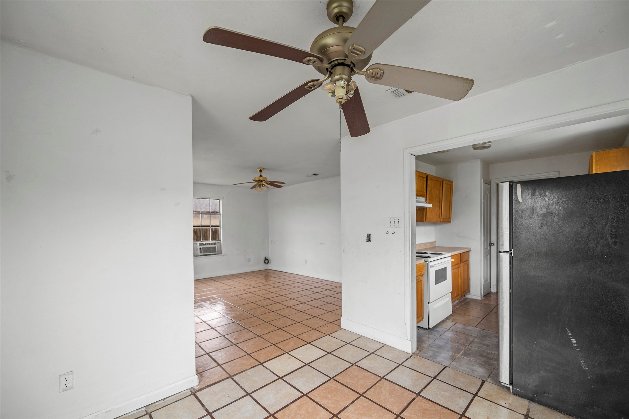 330 3rd Street Hempstead, TX 77445 - Photo 3 of 13 a view of a hallway with a chandelier fan and wooden floor
