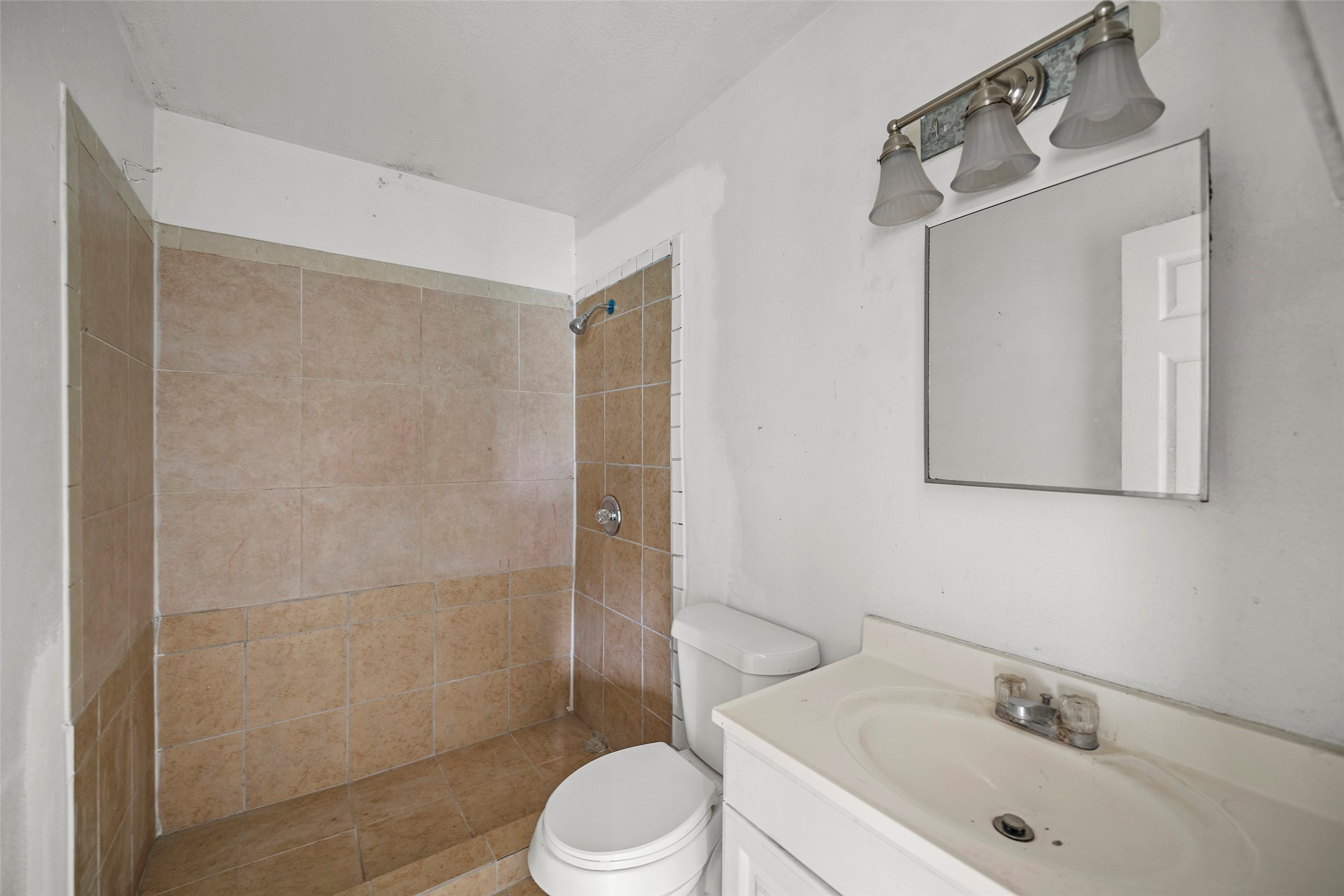 330 3rd Street Hempstead, TX 77445 - Photo 9 of 13 a bathroom with a sink toilet and shower