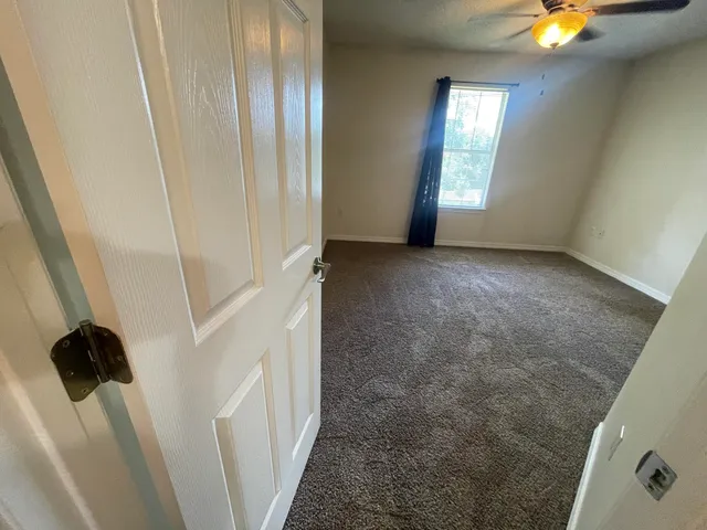 a view of an empty room with windows