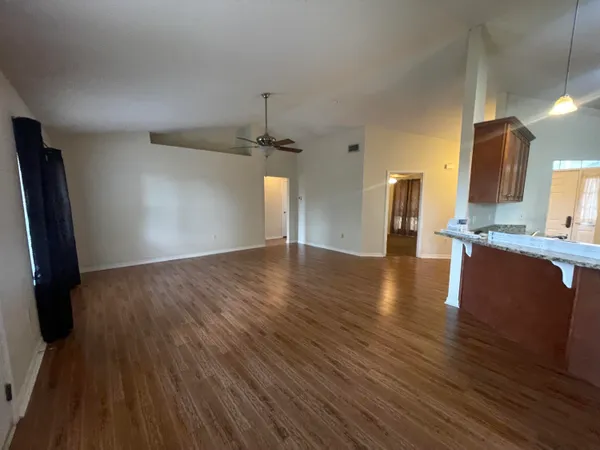 a view of a kitchen center island wooden floor and electronic appliances