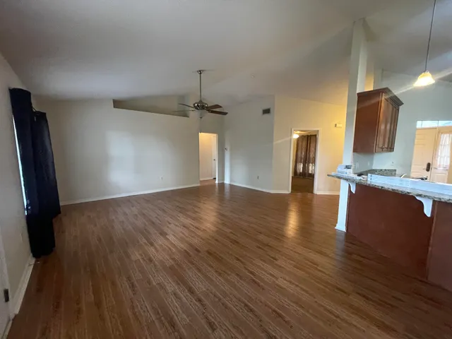 a view of a kitchen center island wooden floor and electronic appliances