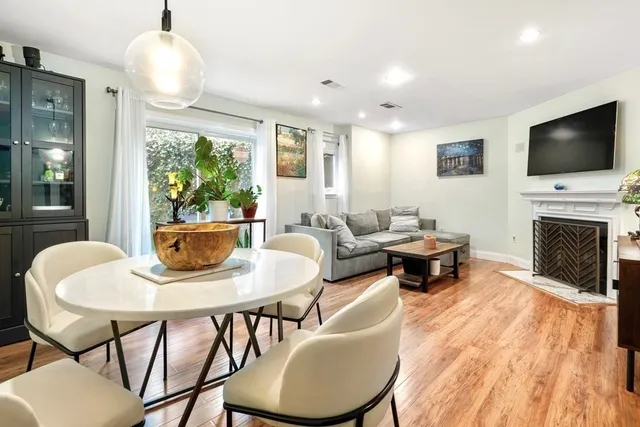 a living room with furniture a flat screen tv and a fireplace