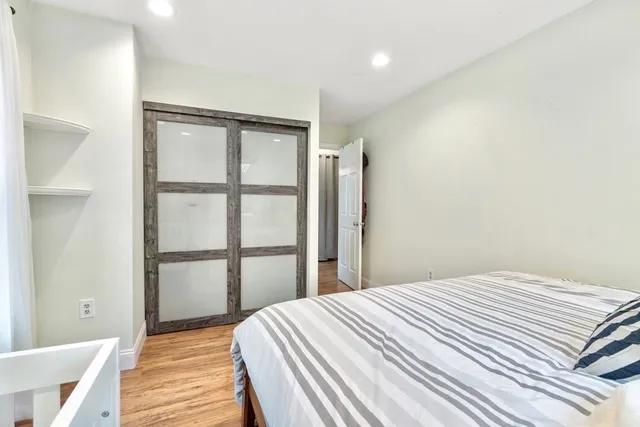 a bathroom with a granite countertop toilet sink and mirror