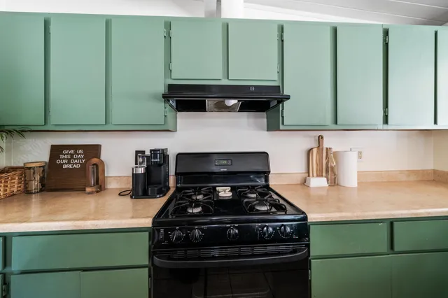 a kitchen with a stove and a cabinets