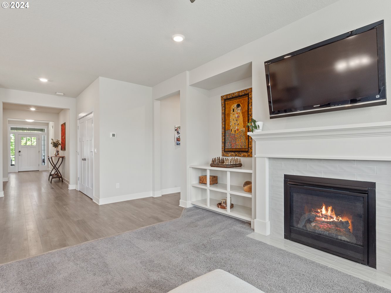 4723 South 17th Way Ridgefield, WA 98642 - Photo 21 of 48 a living room with a fireplace and a flat screen tv