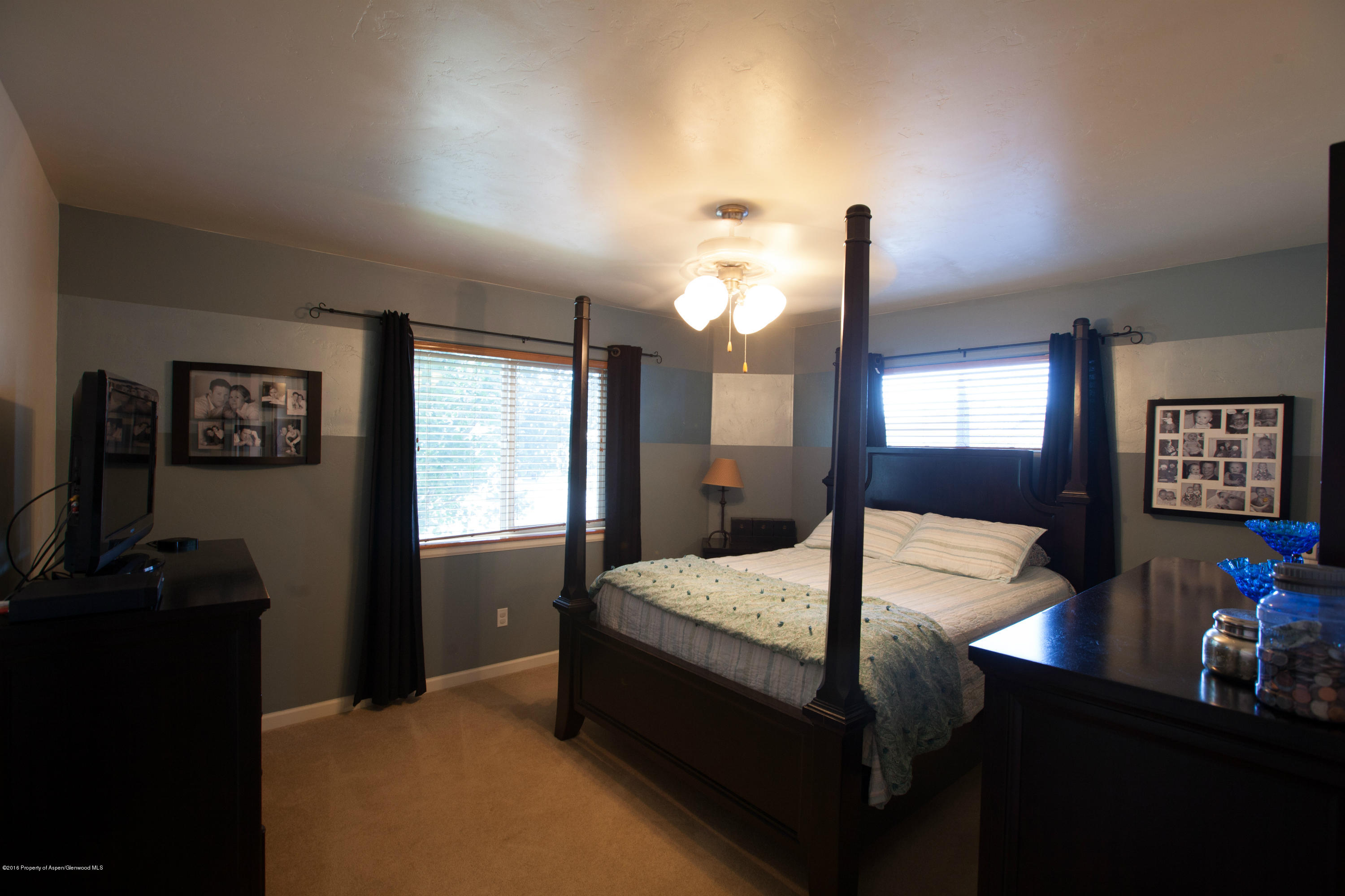 700 East 17th Street Rifle, CO 81650 - Photo 8 of 15 a bedroom with a bed lamp on desk and a window