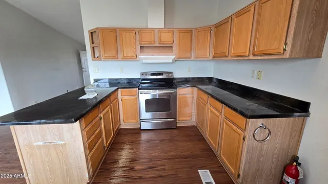 a kitchen with wooden floors and cabinets