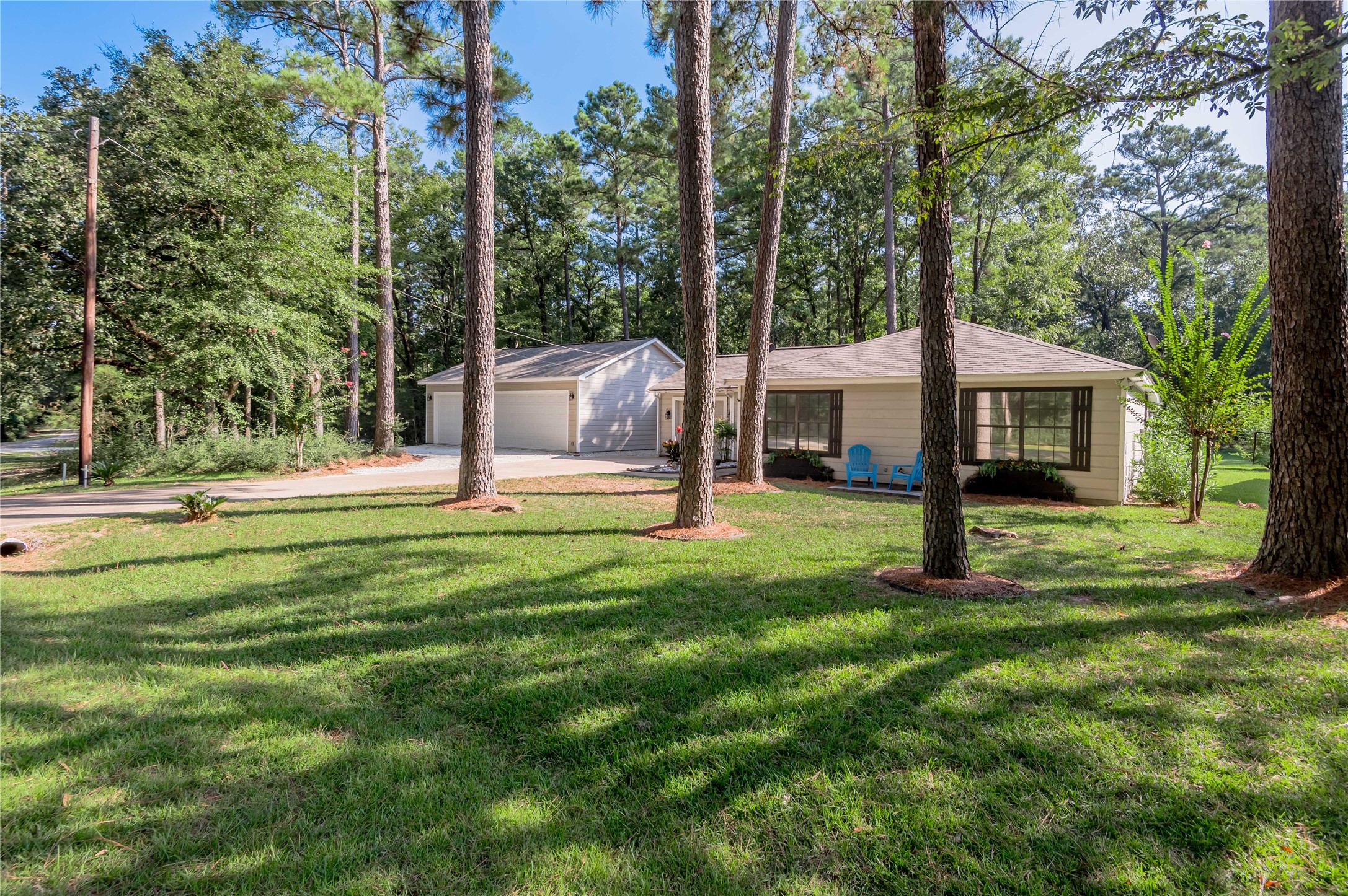 a view of a house with a backyard and a tree