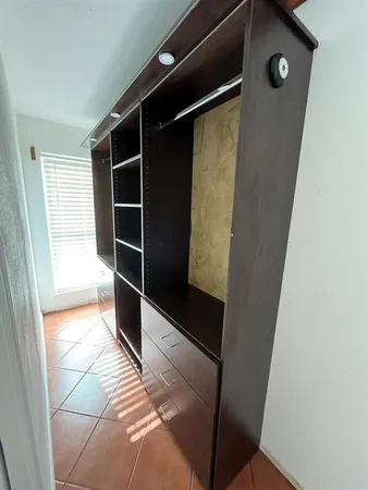 a view of closet area with wooden floor