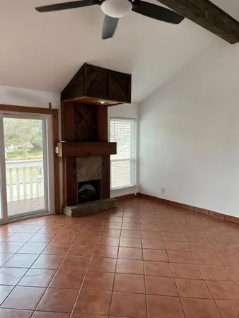 a living room with a fireplace a window and a fireplace