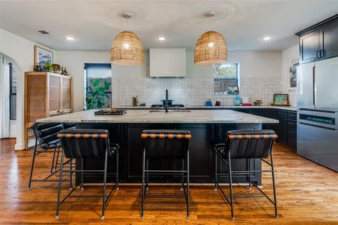 a kitchen with a sink cabinets and window