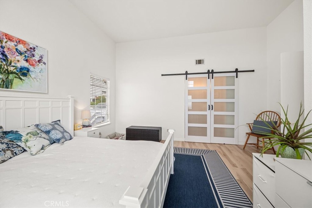 428 Westpoint Drive Pismo Beach, CA 93449 - Photo 18 of 58 a bedroom with a bed and a large window with potted plants