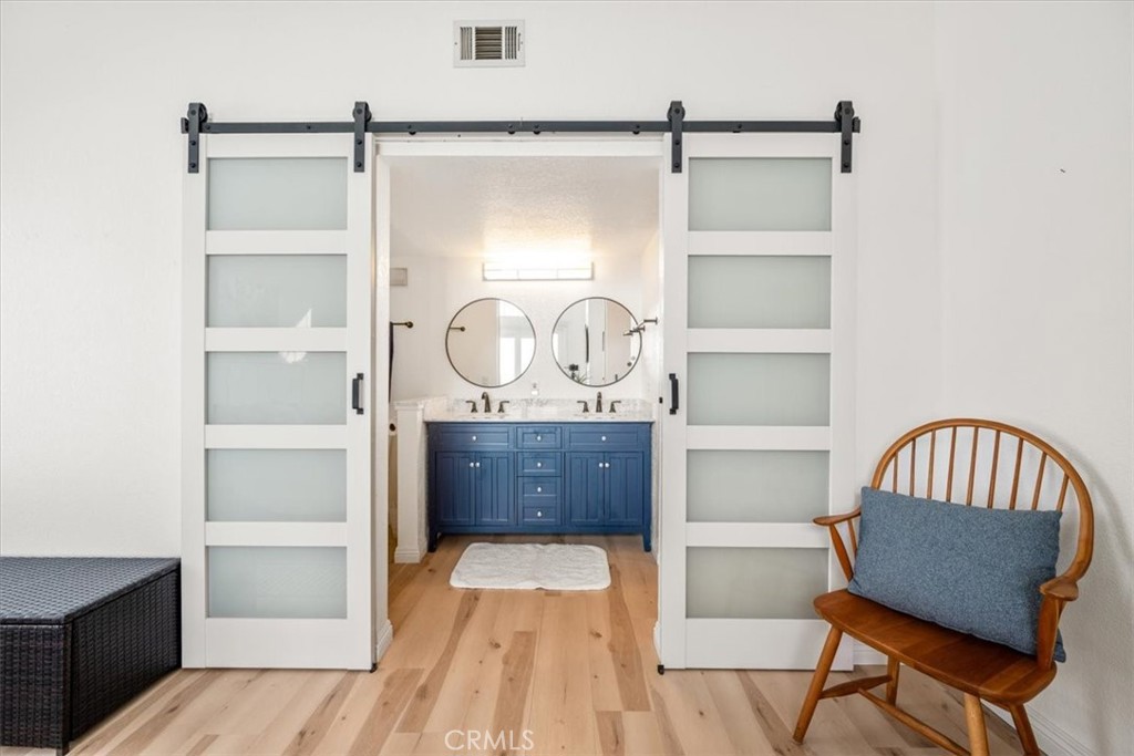 428 Westpoint Drive Pismo Beach, CA 93449 - Photo 19 of 58 a view of a bedroom with furniture and wooden floor