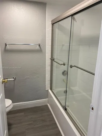 a bathroom with a glass shower door