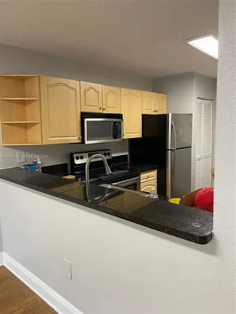 a kitchen with stainless steel appliances a refrigerator and a sink