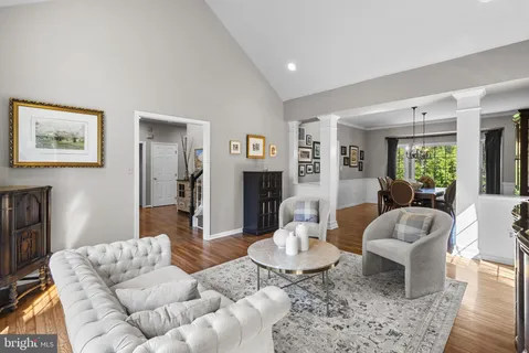 a living room with fireplace furniture and a large window