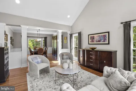 a dining room with furniture a chandelier and wooden floor