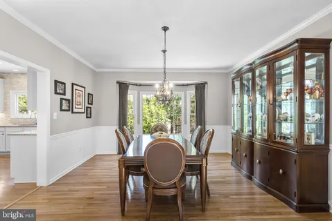 a kitchen with stainless steel appliances granite countertop a refrigerator a sink dishwasher a stove and a refrigerator with wooden floor