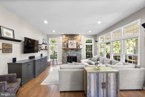 a living room with furniture a fireplace and a flat screen tv