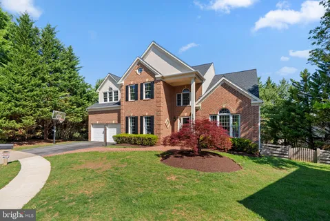 a front view of a house with yard and green space