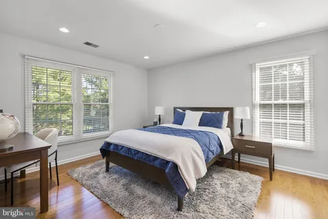 a bedroom with a bed and a table in it