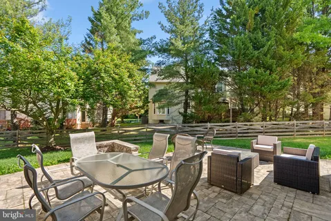 a view of a house with backyard porch and sitting area