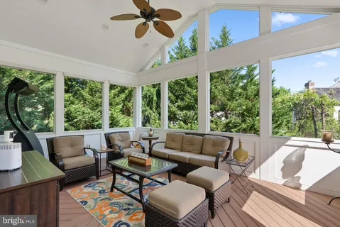 a living room with furniture and a floor to ceiling window