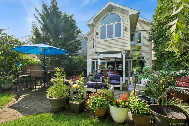 a view of a chair and table in backyard of the house