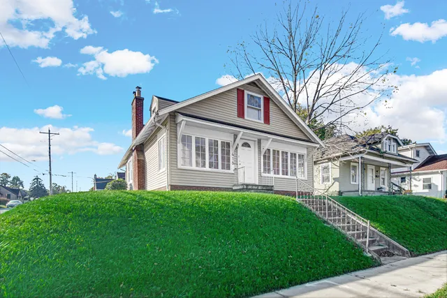 a front view of a house with a garden