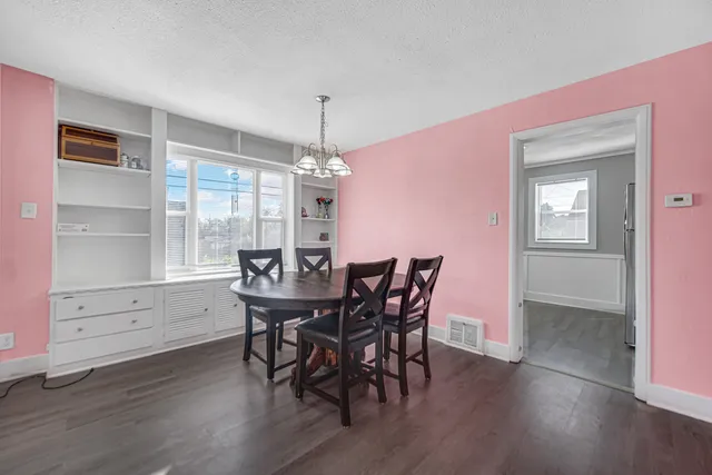 a view of a dining room with furniture and wooden floor