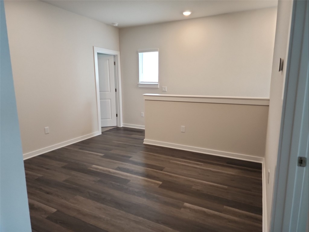 2349 Moon Tower Trail Leander, TX 78641 - Photo 17 of 34 an empty room with wooden floor and windows