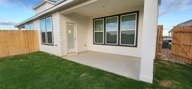 a view of a house with backyard and porch