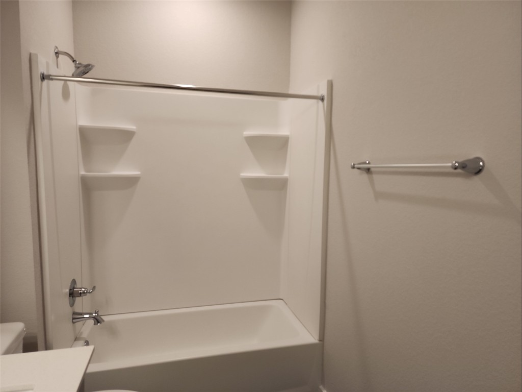 2349 Moon Tower Trail Leander, TX 78641 - Photo 33 of 34 a bathroom with a shower and a bath tub