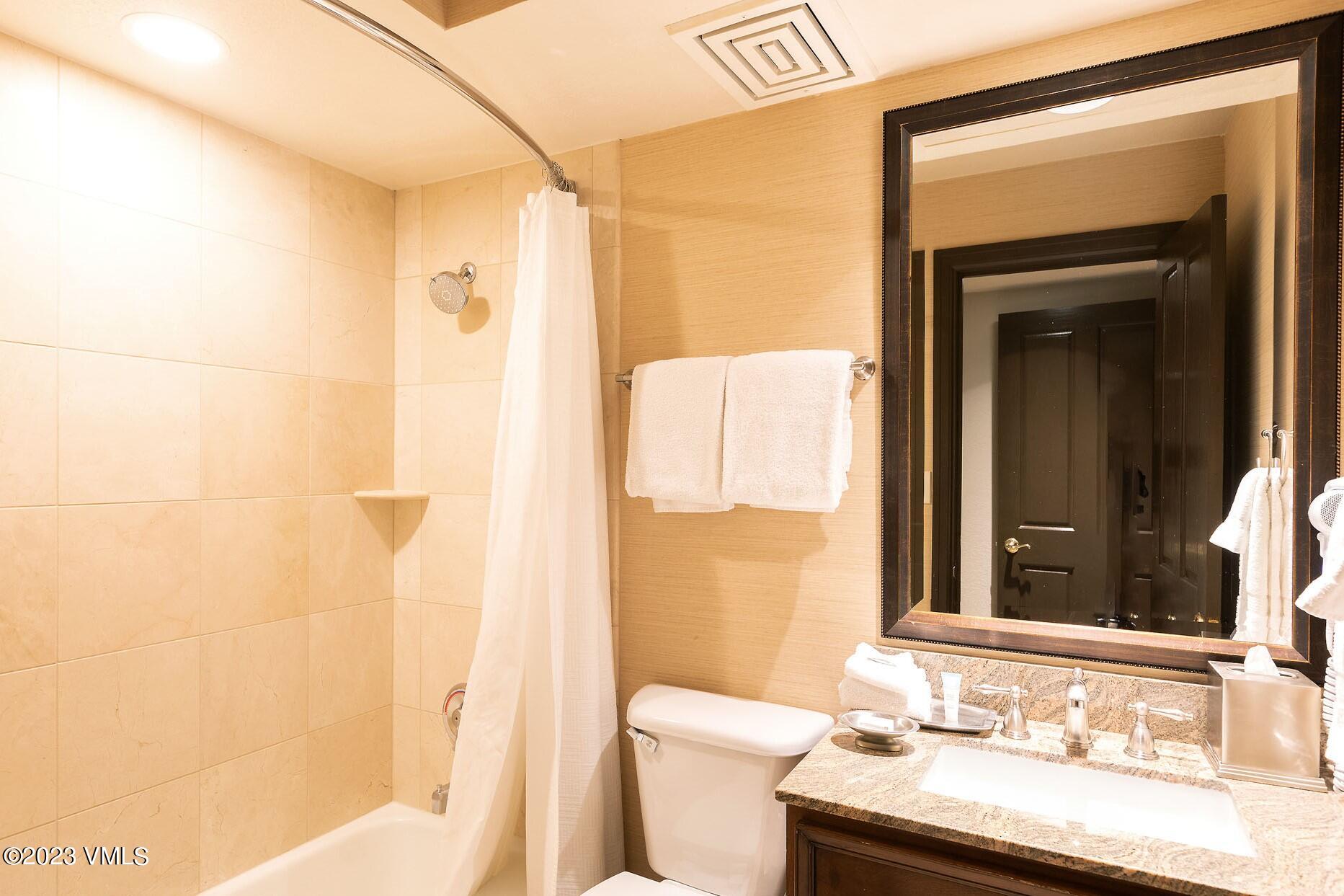 210 Offerson Road, Unit 115 WEEK 33 Beaver Creek, CO 81620 - Photo 11 of 23 a bathroom with a granite countertop sink toilet and shower
