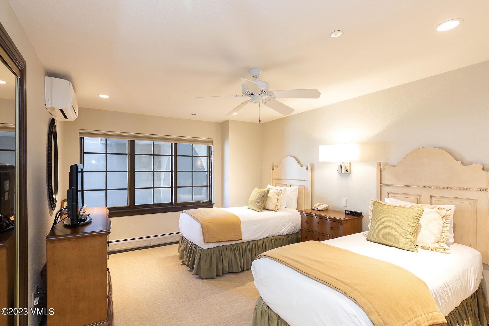 210 Offerson Road, Unit 115 WEEK 33 Beaver Creek, CO 81620 - Photo 8 of 23 a bedroom with two beds and a large mirror